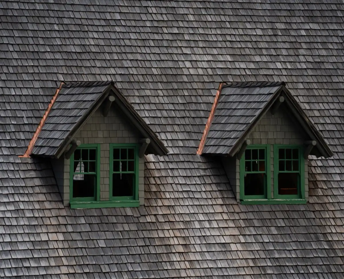 Dormers on a shingle roof in Naples, FL, where step flashing and kickout flashing carry water past the walls
