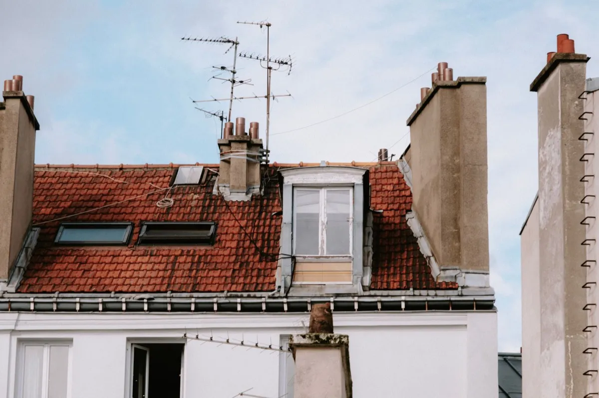 Chimneys and flashing details on a rooftop where leaks commonly begin in Naples, FL